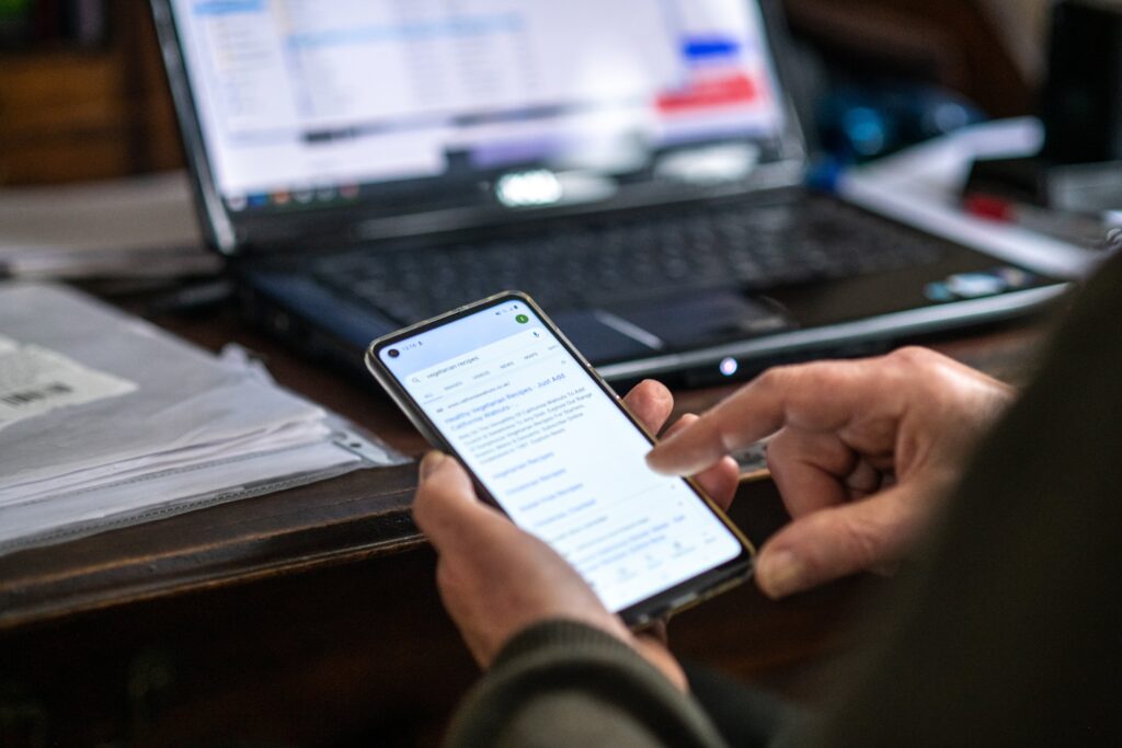 A photo of someone's hands using a smart phone.