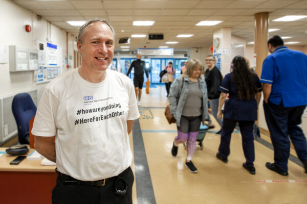 Steve Andrews wearing how are you doing campaign top during Covid