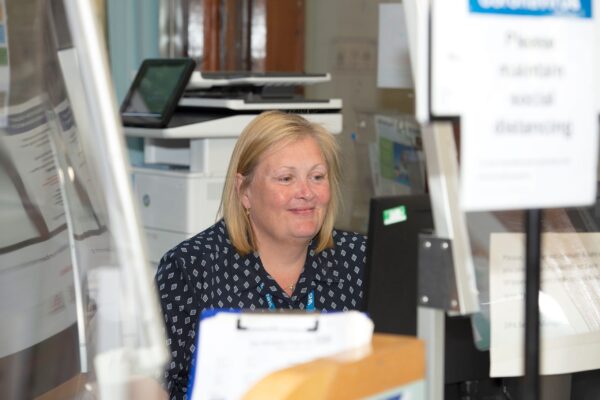 member of back office team sat at her desk