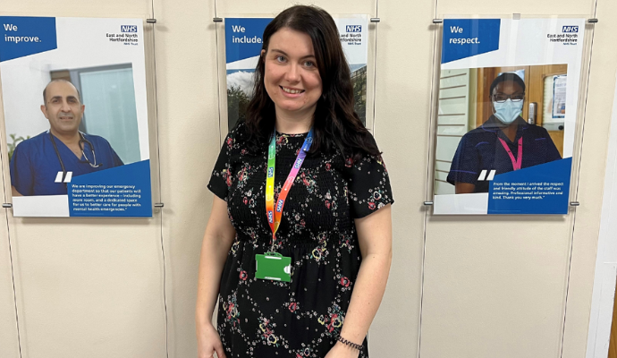 Alex Reekie photographed inside the Trust Management corridor at Lister Hospital. She is pictured smiling toward the camera.